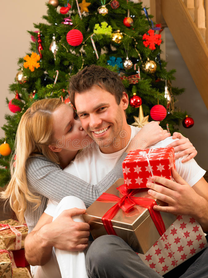 Couples Gift Exchange Ideas
 Young Couple With Gifts In Front Christmas Tree Stock