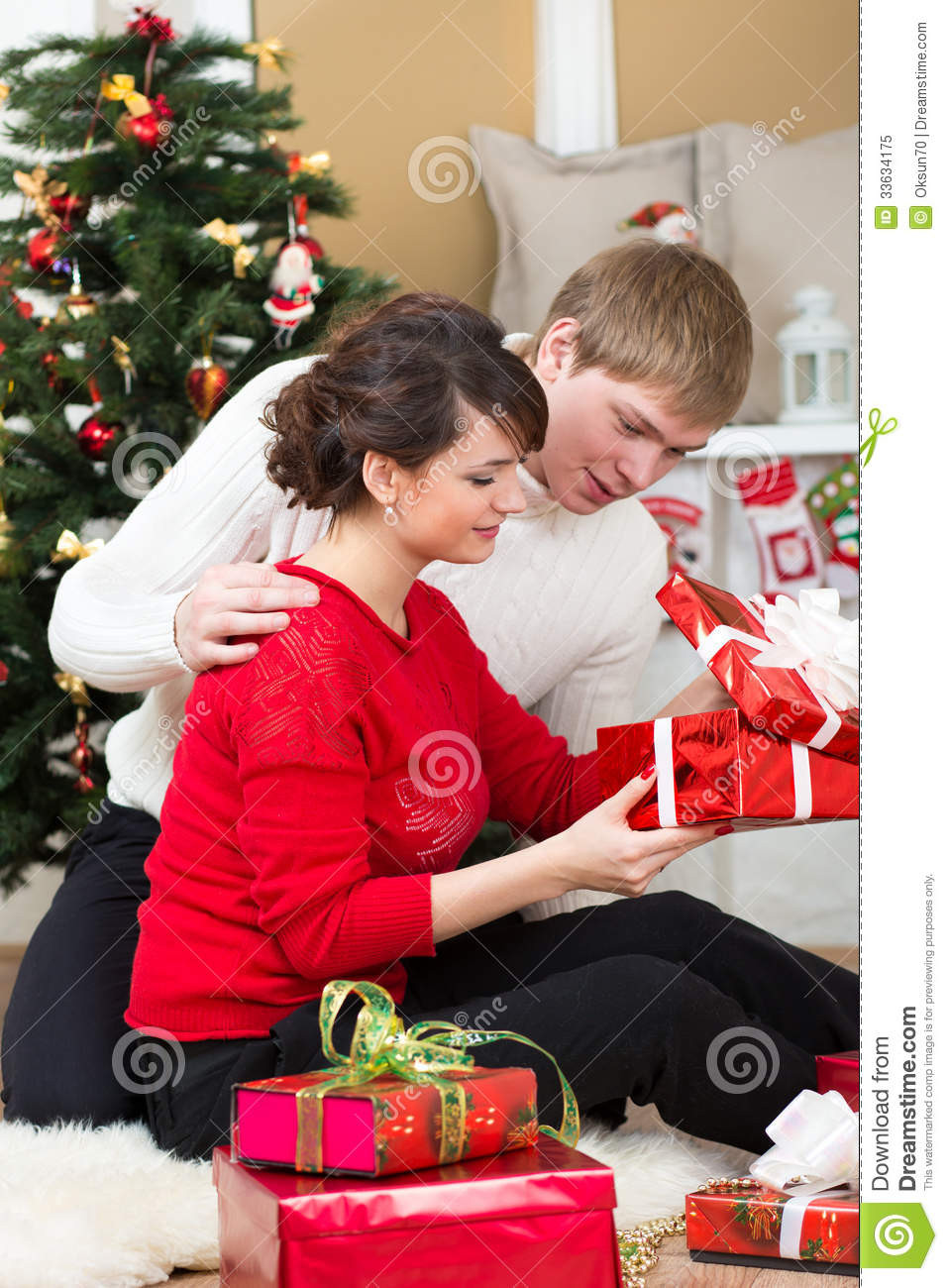 Best ideas about Gift Ideas For Young Couples
. Save or Pin Young Couple With Gifts In Front Christmas Tree Royalty Now.