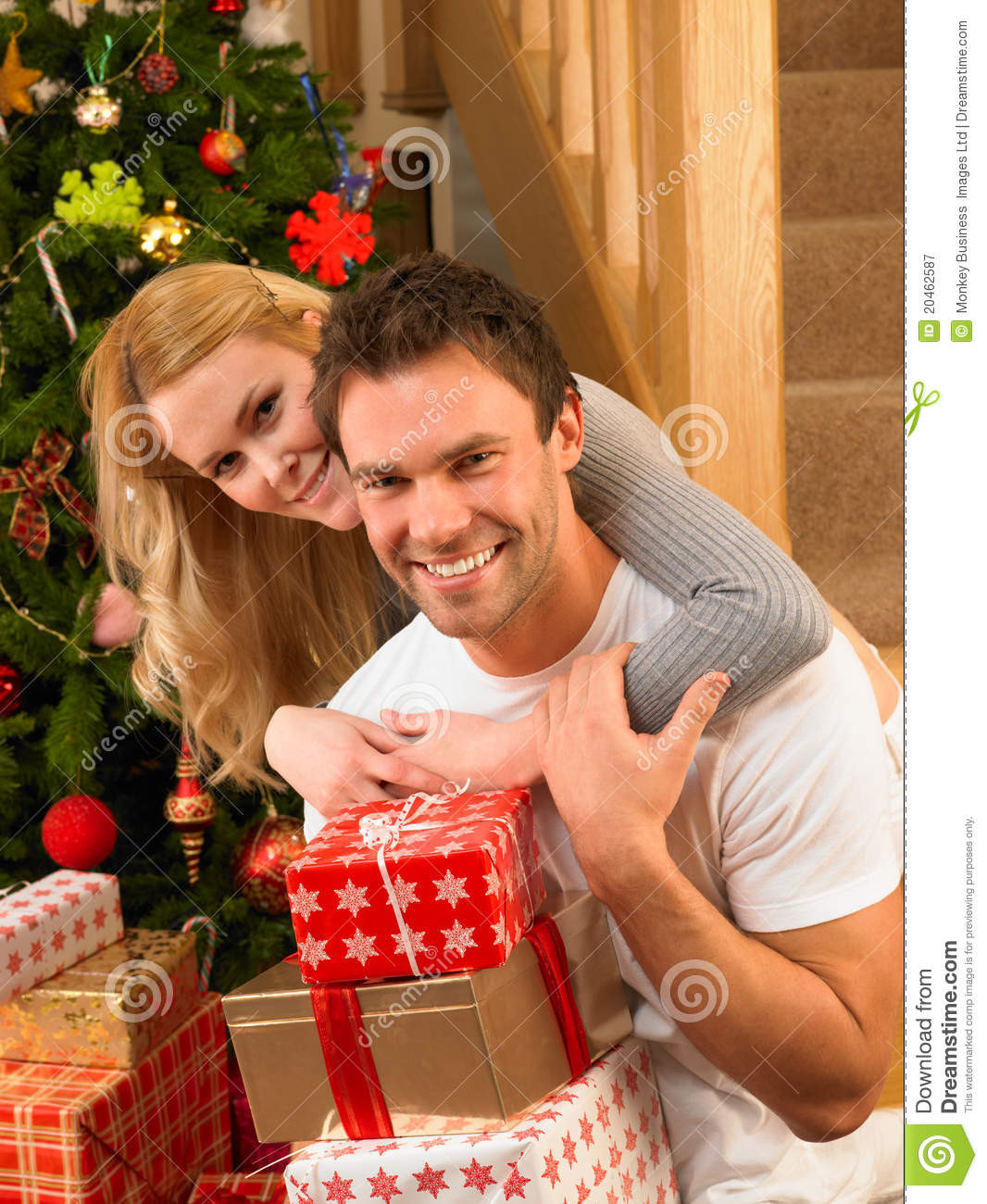 Best ideas about Gift Ideas For Young Couples
. Save or Pin Young Couple At Christmas Exchanging Gifts Royalty Free Now.